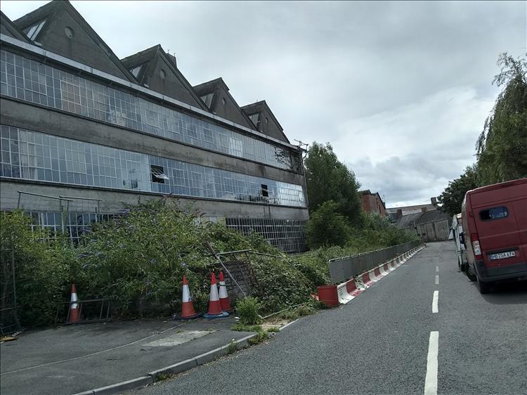 Scruffy old industrial buildings with glass and concrete at Glastonbury