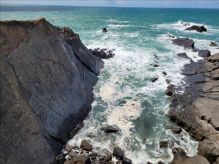 Looking down the steep rock faces to the ocean below at Hartland Quay