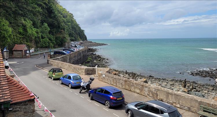 Looking down onto the coastal road and the bay at Lynton with tree covered cliffs