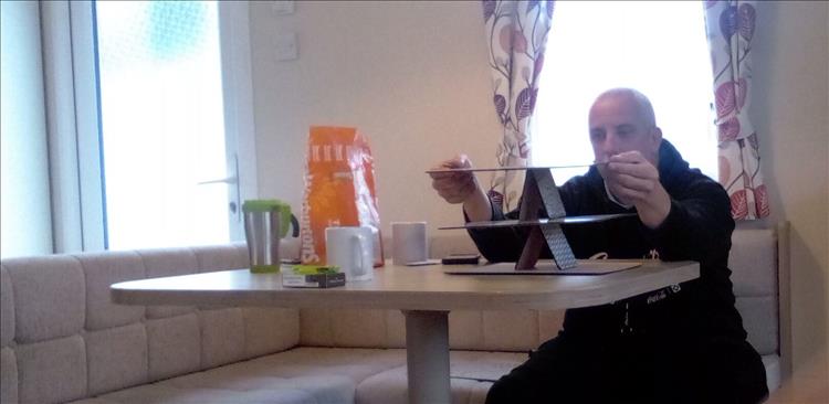 Rik balances a stack of place mats as you might stack playing cards