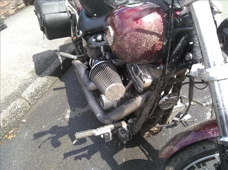 The once pristine chrome and paint of Riks motorcycle is now covered in mud