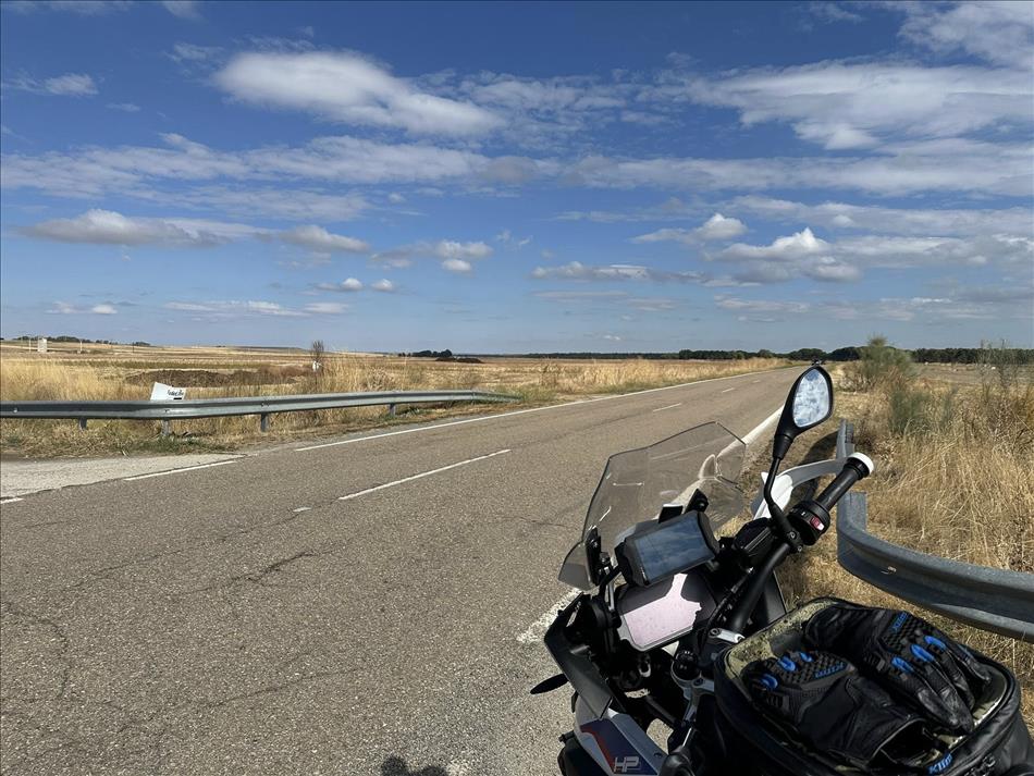 Flat yellow grass plains and Andy's bike beside the lonesome road