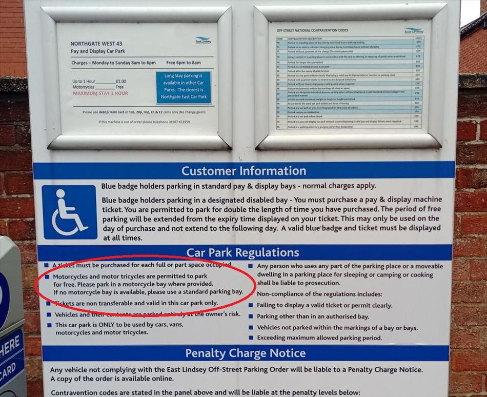 A regular parking information board with the section about motorcycles parking for free circled