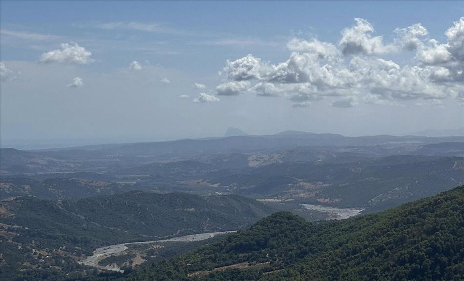 Across a mountain range in the far far distance we can make out the pointy triangular Rock of Gibralter
