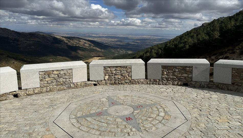 A mirador, viewpoint, with a compass set in stone and enormous views across a plain below the hills