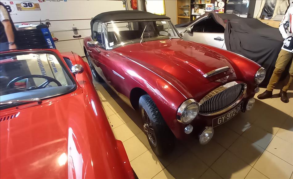 A dark red sports car from the 50s or 60s