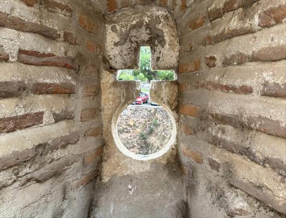 Set deep into the castle wall is a cross and circle cut-out presumanly for archers to shoot out of