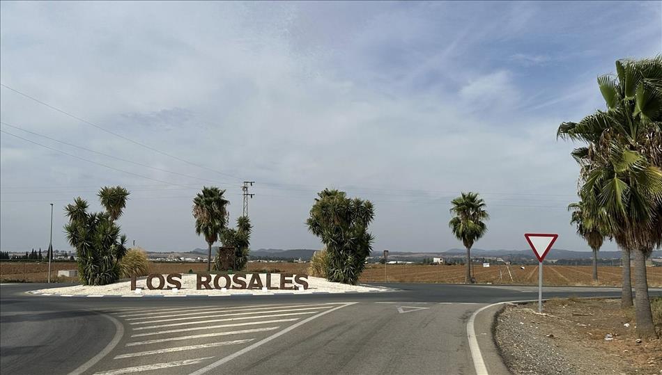 Mostly we see dusty roads and a roundabout, a few palm trees but away in the far hazy distance more mountains