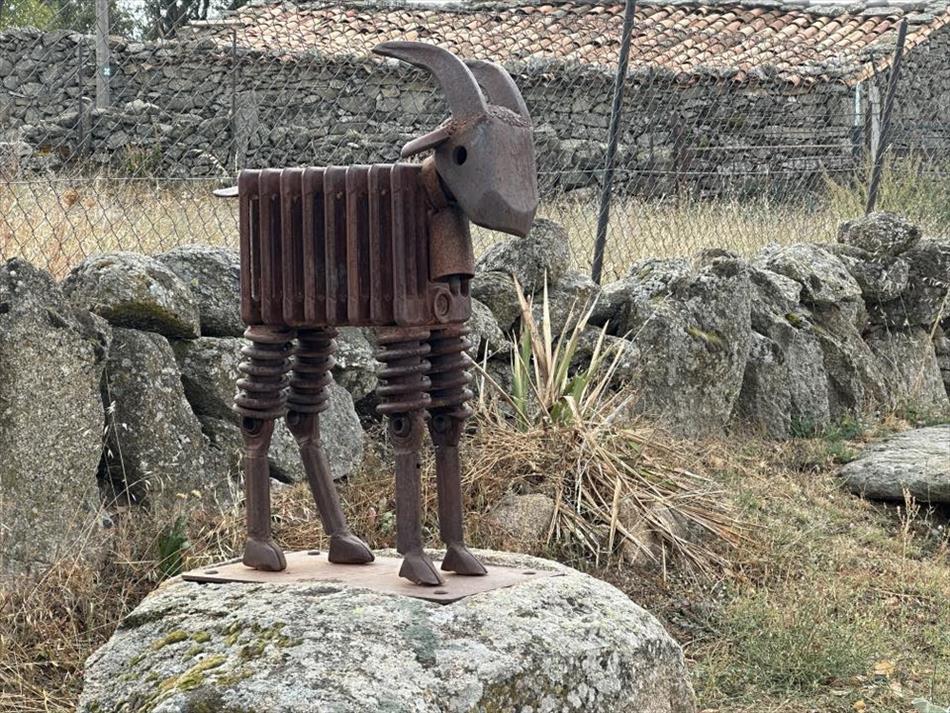 A goat made from rusty old radiators, springs and the like