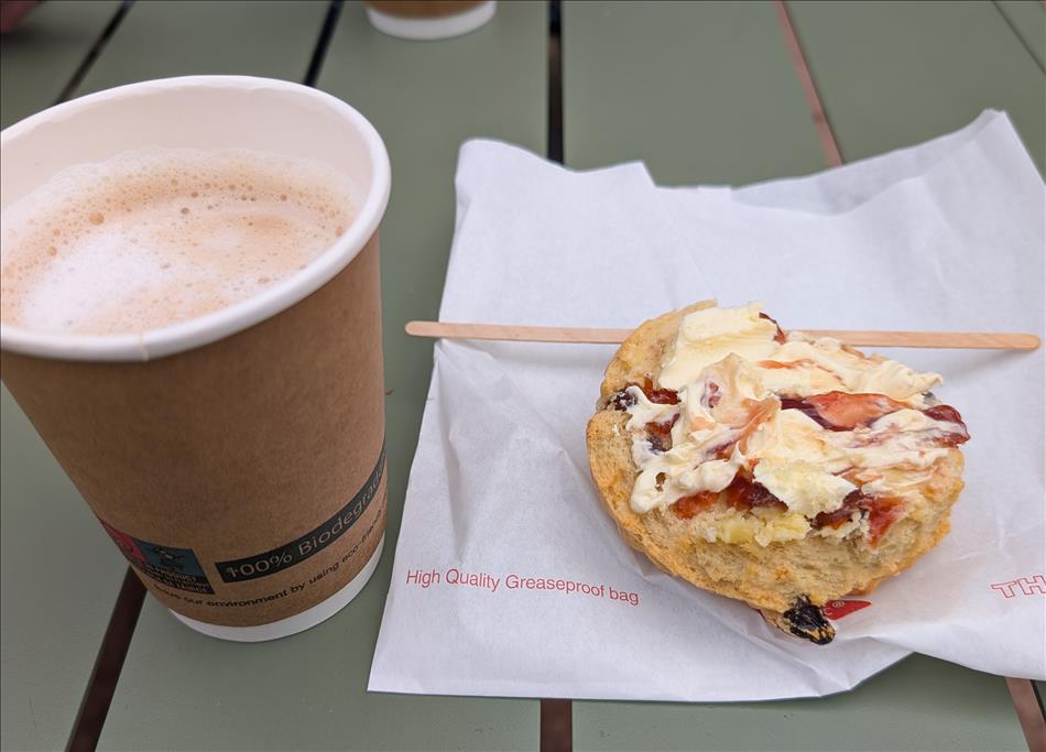 tea and coffee in paper cups and a scone