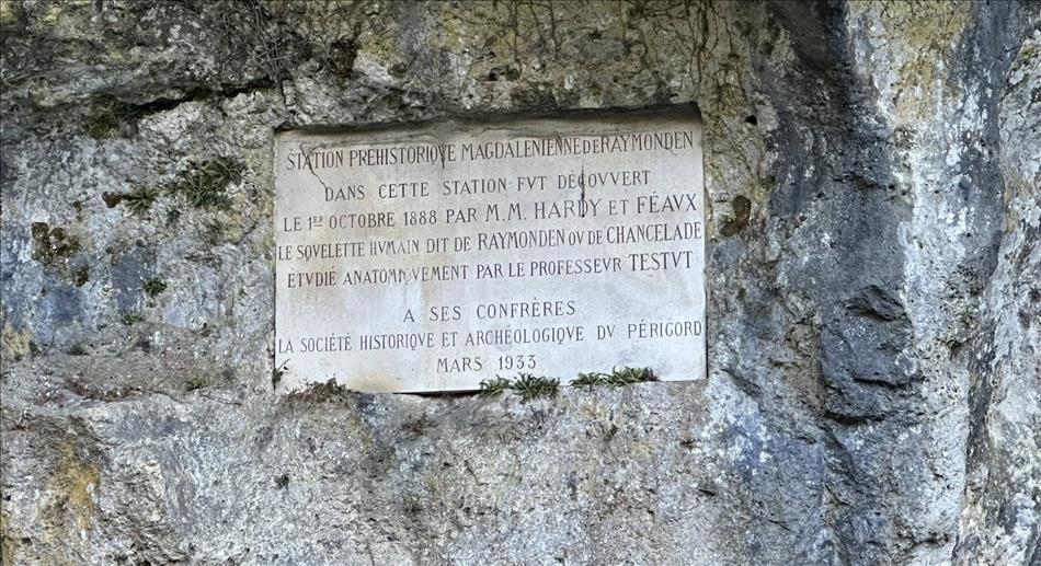 The sign is etched into a stone placard inset into the rock