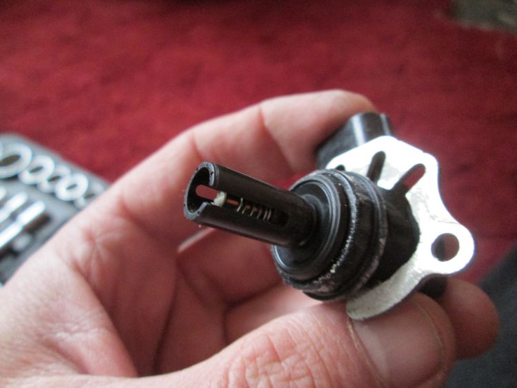 A tiny stepper motor and a plunger forms the idle air control valve