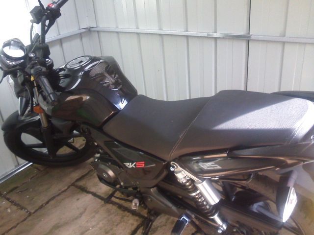 the bike seen from inside the white shed