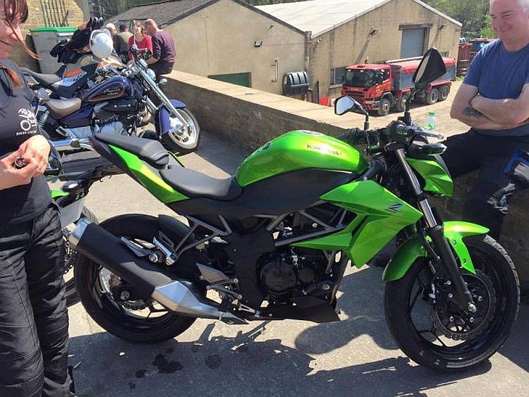 Sharon and her friend DW admire the gleaming Kawasaki in the sun