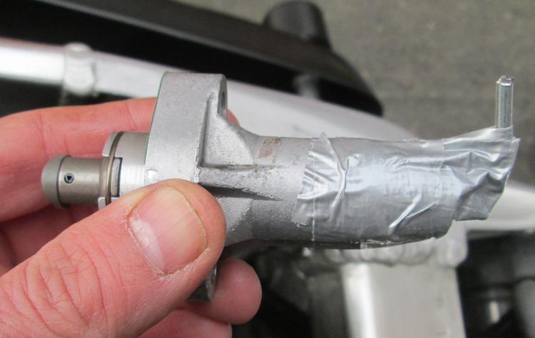 The tool gaffer taped into the tensioner to hold the spring back