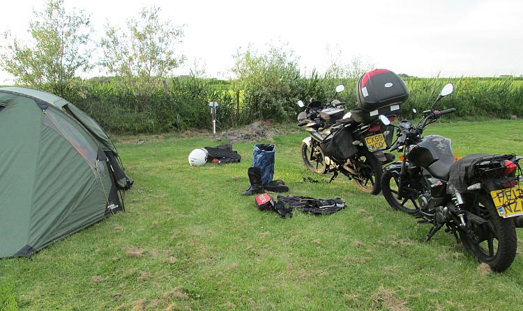 2 motorcycles and a tent on a campsite in The Netherlands