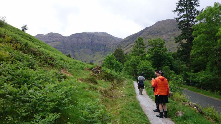 3 men walking through Glencoe looking for hagrids hut. One is wearing a black skirt