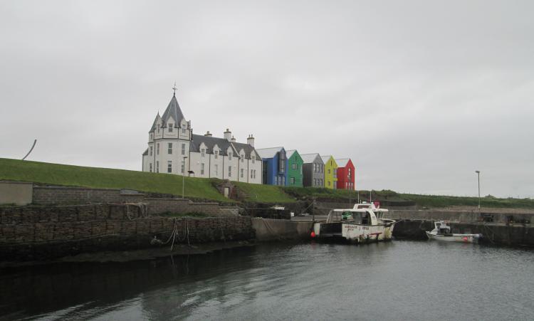 Strange old gothic building with new brightly coloured modern buildings attached