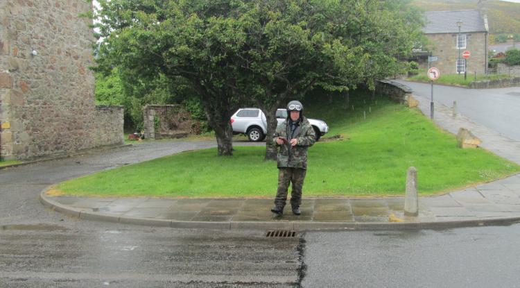Nick stands in all his wet weather bike gear looking soaked through