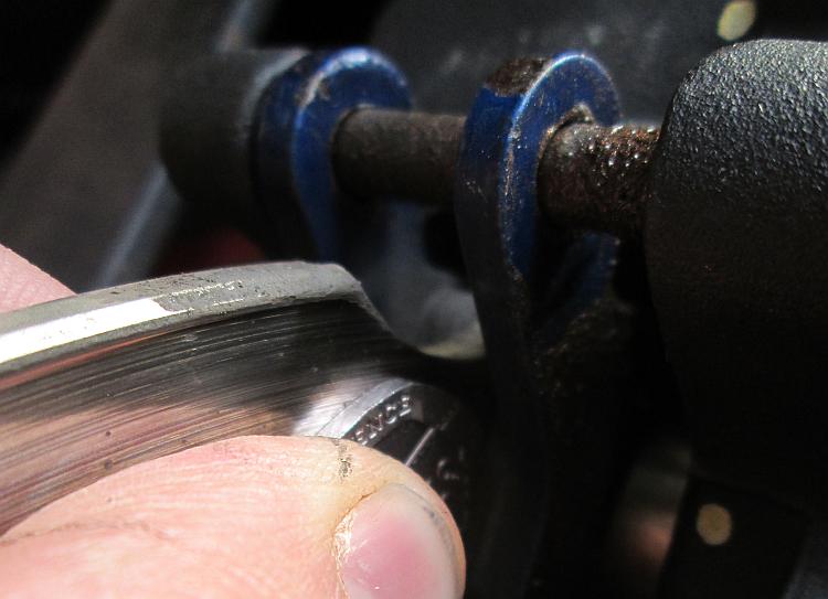 A 20 pence coin next to the rear pads on a CB500X