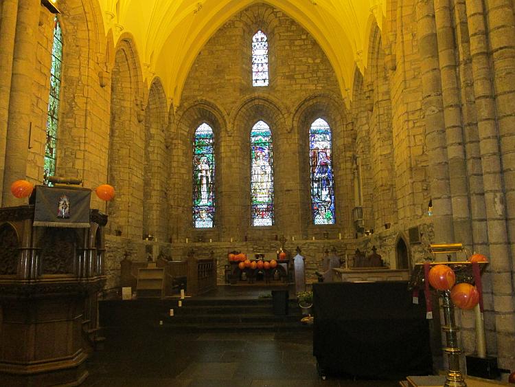 Inside the church at Dornoch with stained glass windows and and vaulted ceilings
