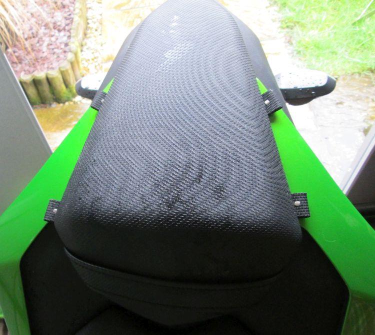 Seen from above the seat the 4 loops just poke out from under the rear seat