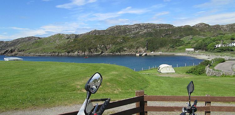 Angular hills lead down to pebble covered shore at Scourie