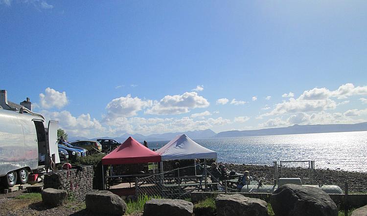 The sea and the islands set against a blue sky seen from the Applecross pub